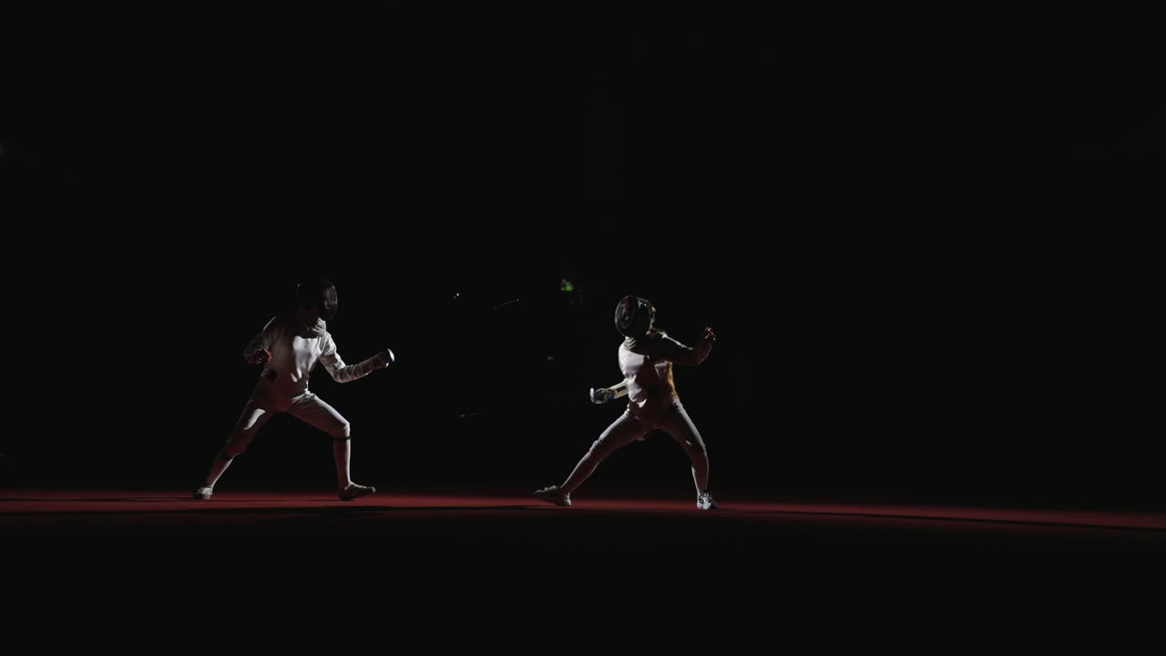 Two Fencers Competing In A Match