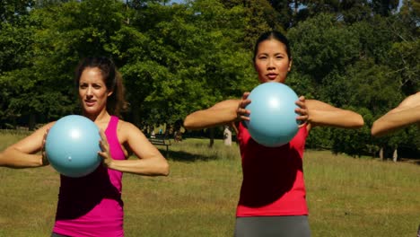 fitness group working out with medicine balls