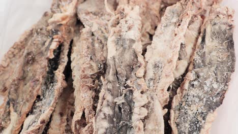 pack of dried fish on a white container