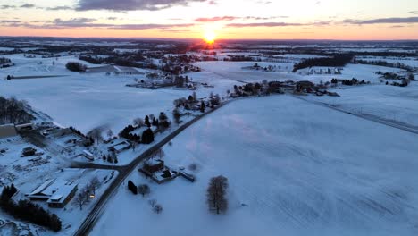 high and wide aerial shot of rural snow-covered country farmland and fields in usa