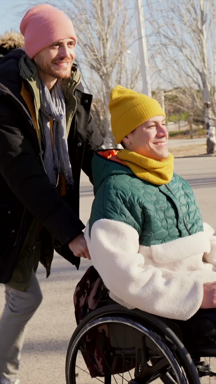 Friend helping man in wheelchair