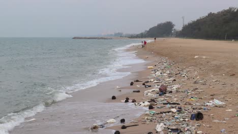 garbage washed ashore on sandy beach