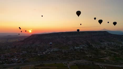hot air balloons rising over cappadocia during sunrise, creating a magical view