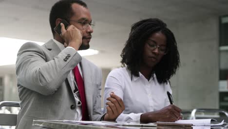 Serious-bearded-businessman-talking-on-smartphone