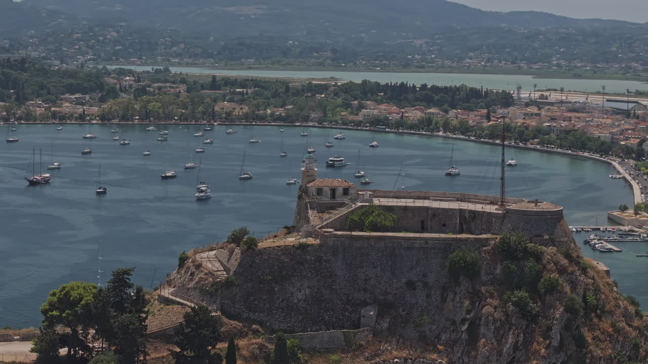 Corfu Greece Aerial v8 zoomed flyover the Old Fortress on the promontory, capturing stunning views of Garitsa Bay, the marina, and the historic townscape - Shot with Mavic 3 Pro Cine - July 16th 2024