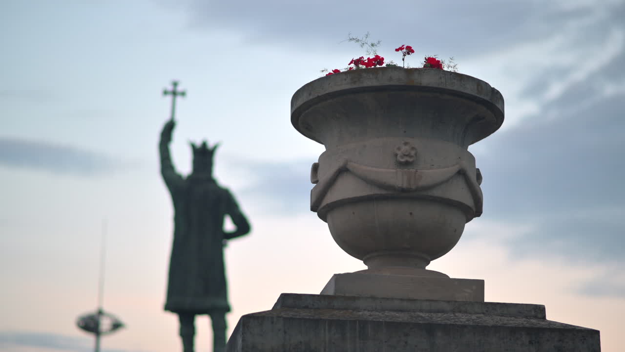 Chisinau, Moldova - June 5, 2021: Close up of an outside flower pot in the city centre with the Stephen the Great Monument on the background