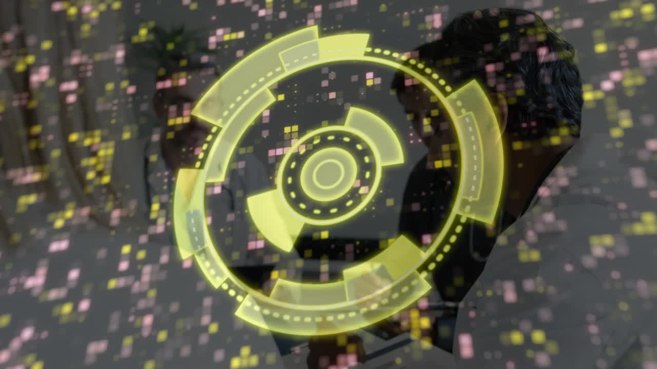 Yellow digital interface animation over people working on computers in office