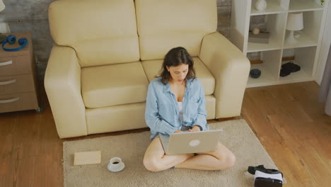 typing an email sitting on the floor