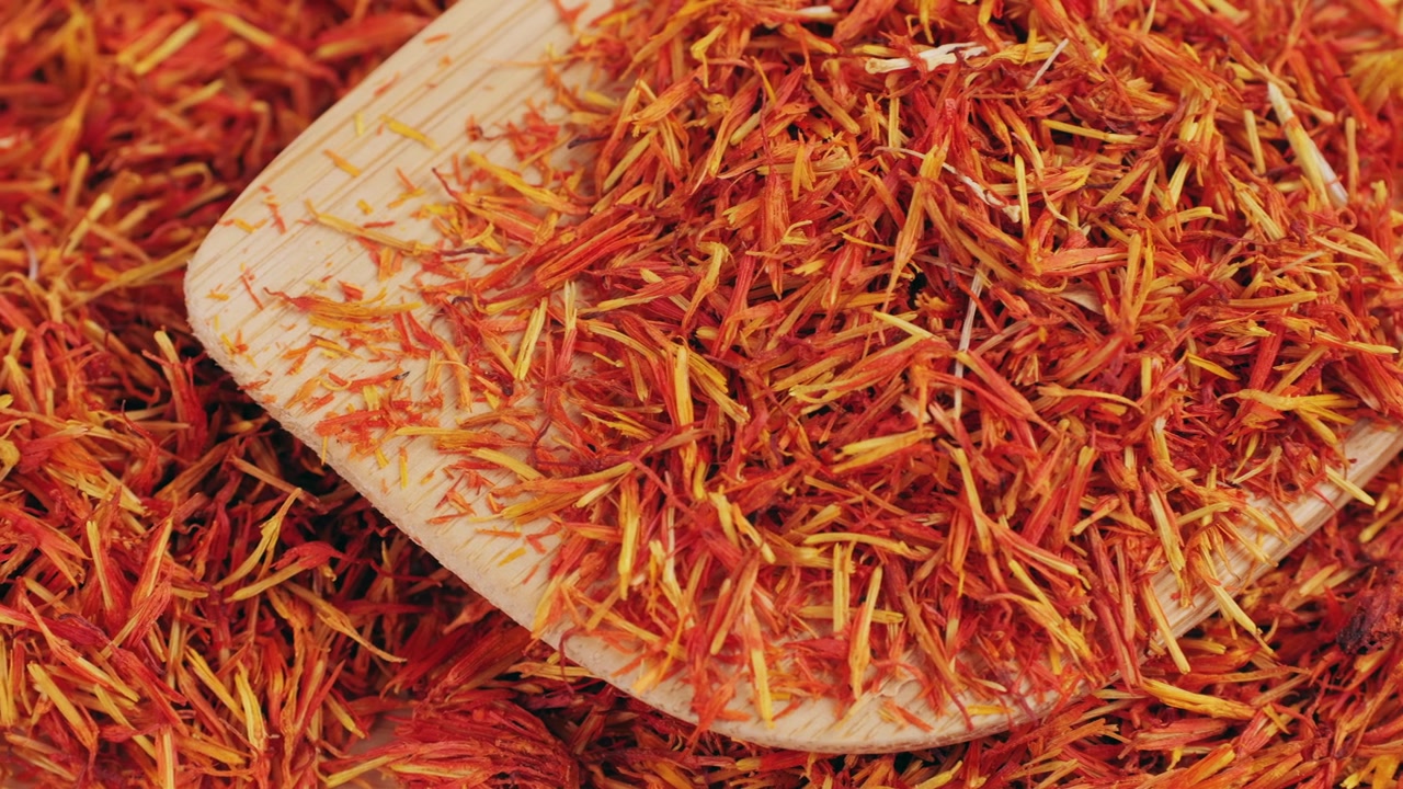 Dried Safflower Petals with a Wooden Spoon
