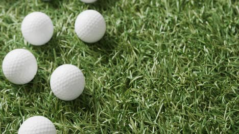 Close-up-of-golf-balls-on-grass,-copy-space,-slow-motion