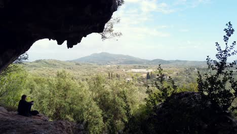 Stunning-aerial-view-flight-drone-footage-flying-forwards-out-of-a-big-cave-in-a-mountain