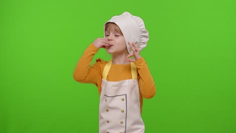 Child-girl-dressed-in-apron-like-chef-cook-showing-approval-ok-sign,-tasty-gesture,-chroma-key