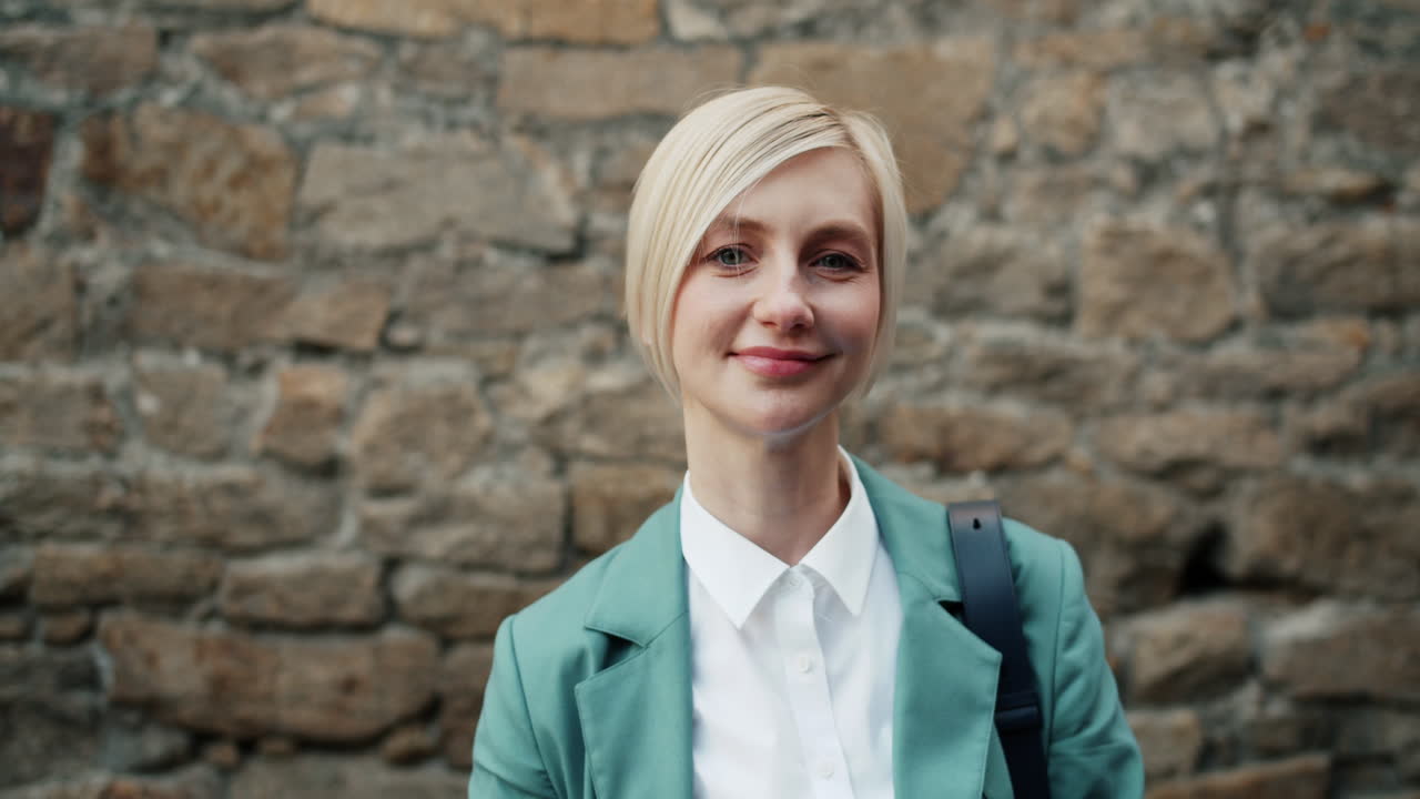 Smiling Businesswoman in Teal Blazer