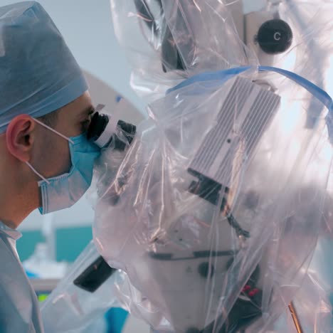 doctors perform a neurosurgery. two neurosurgeons looking into contemporary microscope during microsurgery in the operating theatre.