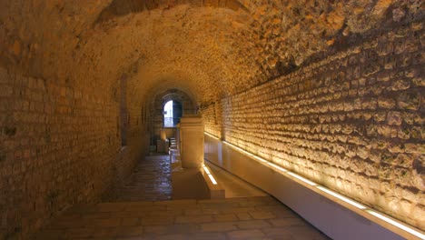 view of a narrow corridor situated inside of the circo romano in spanish city tarragona - handheld shot