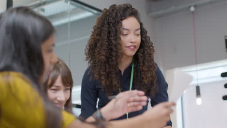 businesswoman presenting to group of colleagues