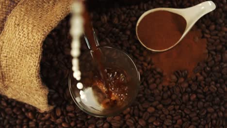 coffee pouring into a glass cup