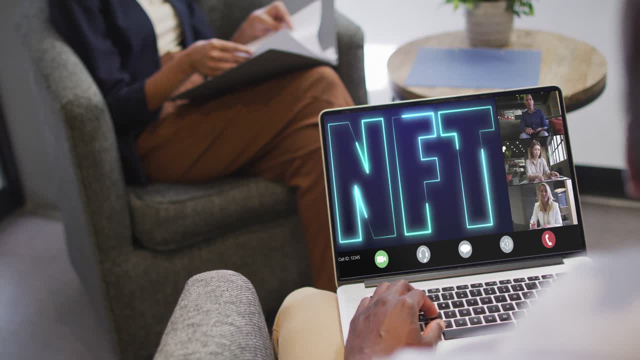 African american businessman using laptop for video call with diverse business colleagues