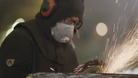 industrial worker grinding metal