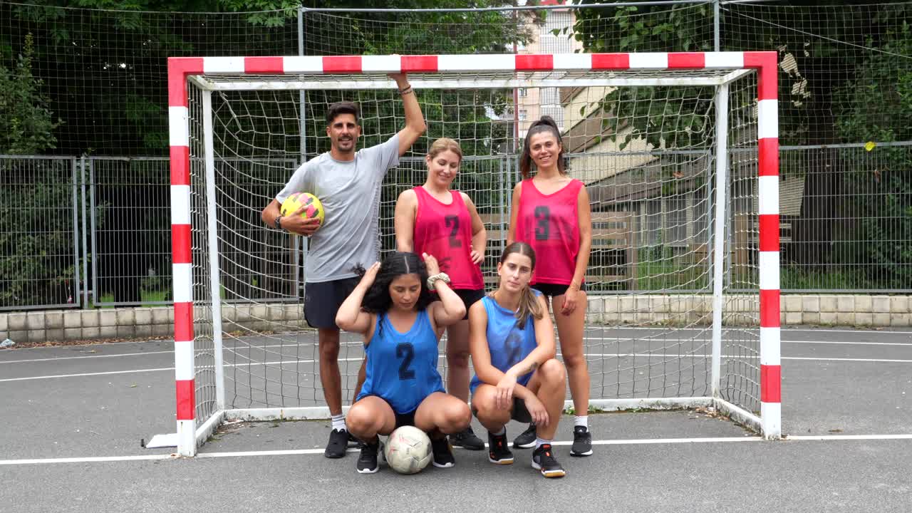 Team posing in front of soccer goal