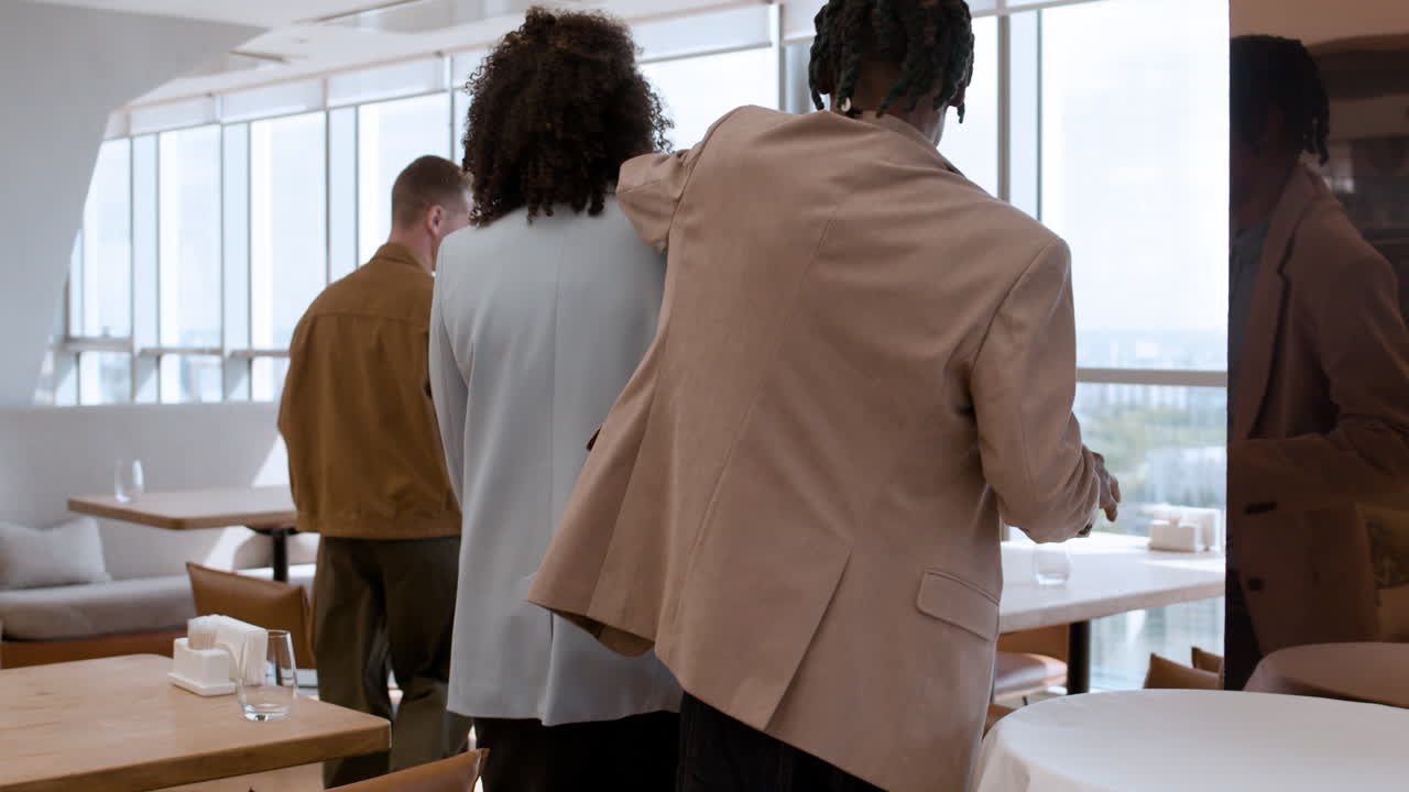 People enjoying lunch at a modern cafe with city views