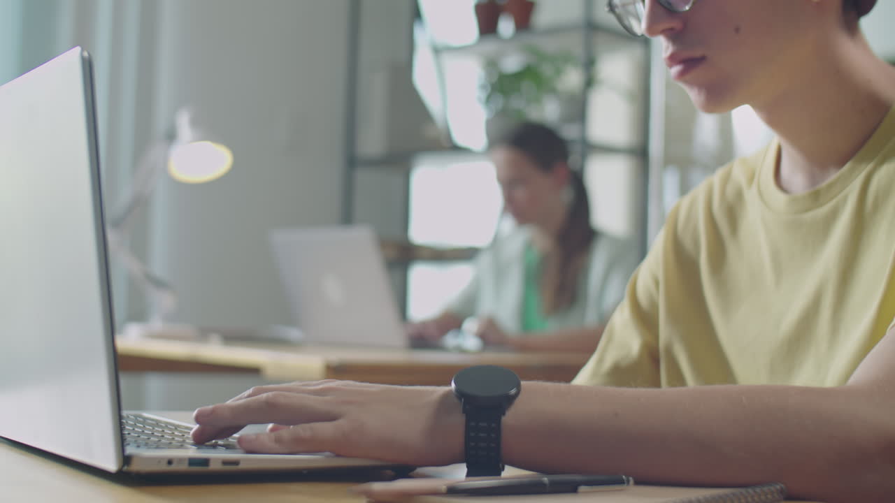 Young Man Using Laptop in Office