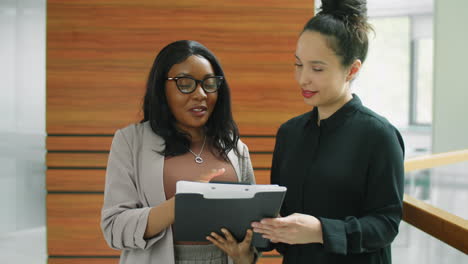 multiethnic businesswomen discussing papers