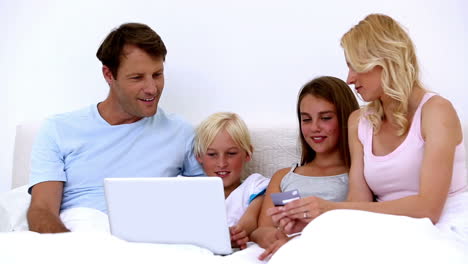 cute family using laptop to shop online together