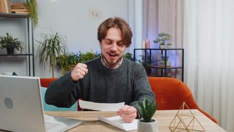 man open envelope letter reads it feel happy career growth advance promotion bank loan approve