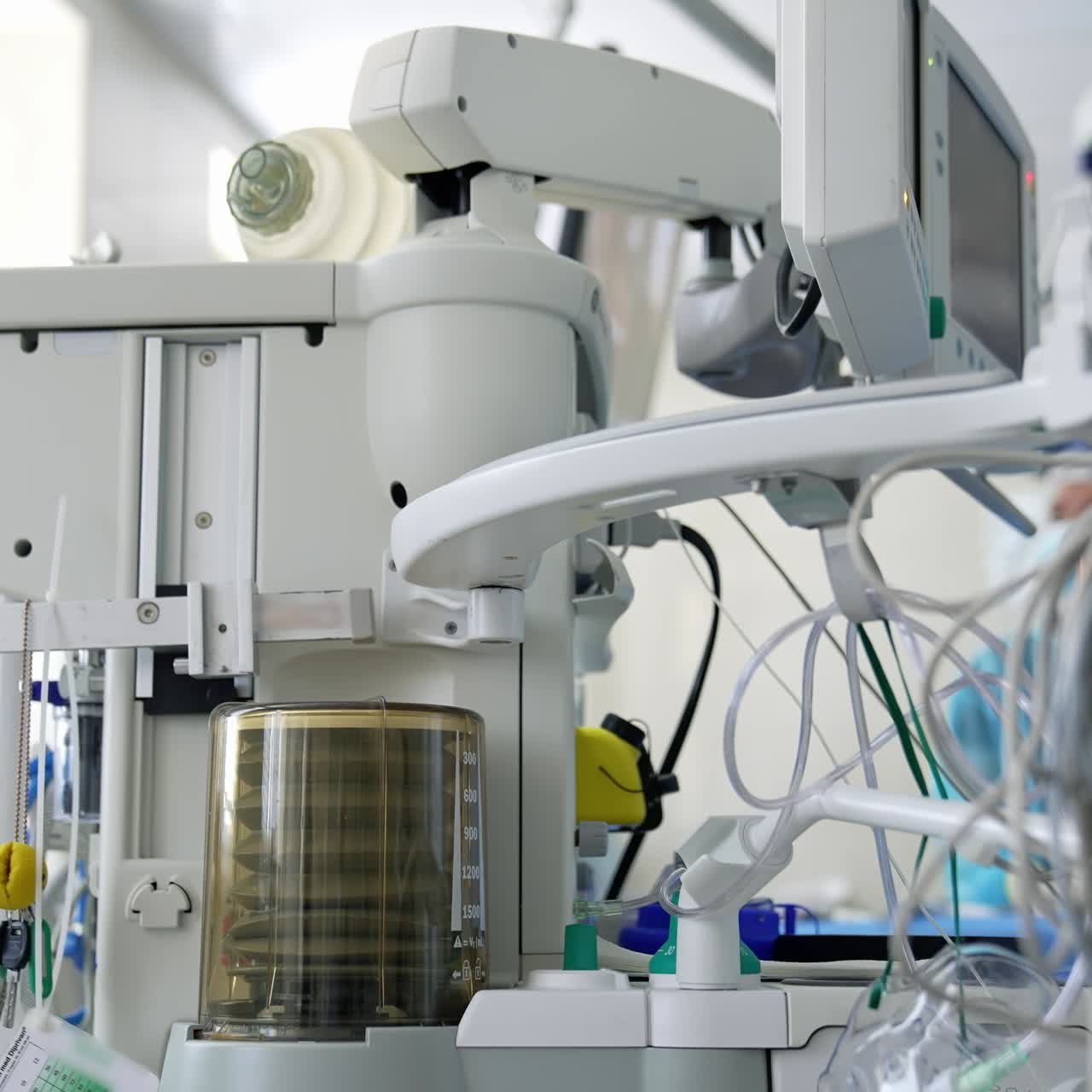 Anaesthesia machine ventilator. Medical equipment for saving patient's life in the operating room on the blur background of doctors. Close-up