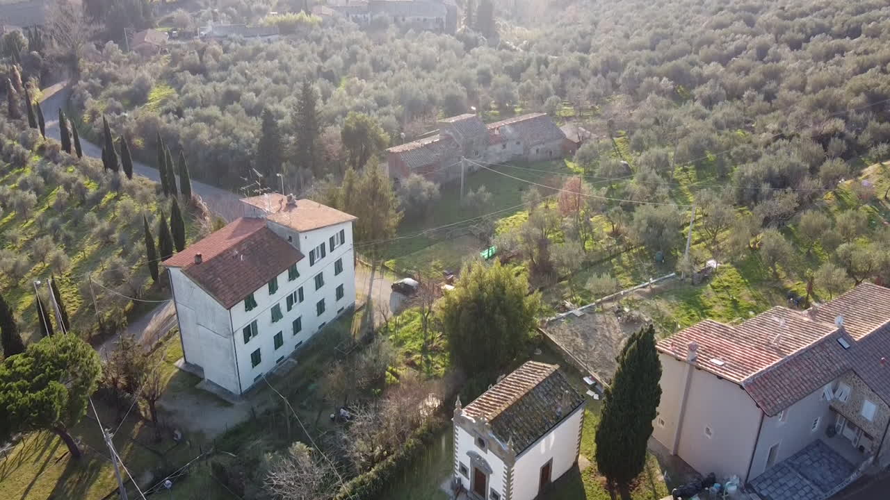 Revealing aerial of Barocco stye 17th century Immacolata Concezione Casabiondo church near to the main villa  in the Florence surrounding hills. Winter season at sunset