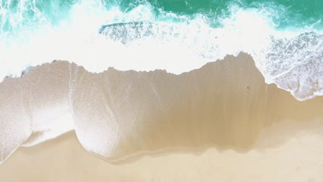 Aerial-view-of-waves-and-a-beach-at-Foz-do-Arelho-Beach,-Caldas-da-Rainha,-Portugal