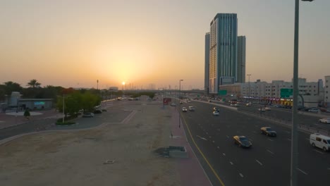Experience-the-captivating-beauty-of-a-Dubai-highway-during-a-stunning-sunset,-with-a-multitude-of-cars-creating-a-mesmerizing-scene