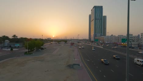 experience the captivating beauty of a dubai highway during a stunning sunset, with a multitude of cars creating a mesmerizing scene