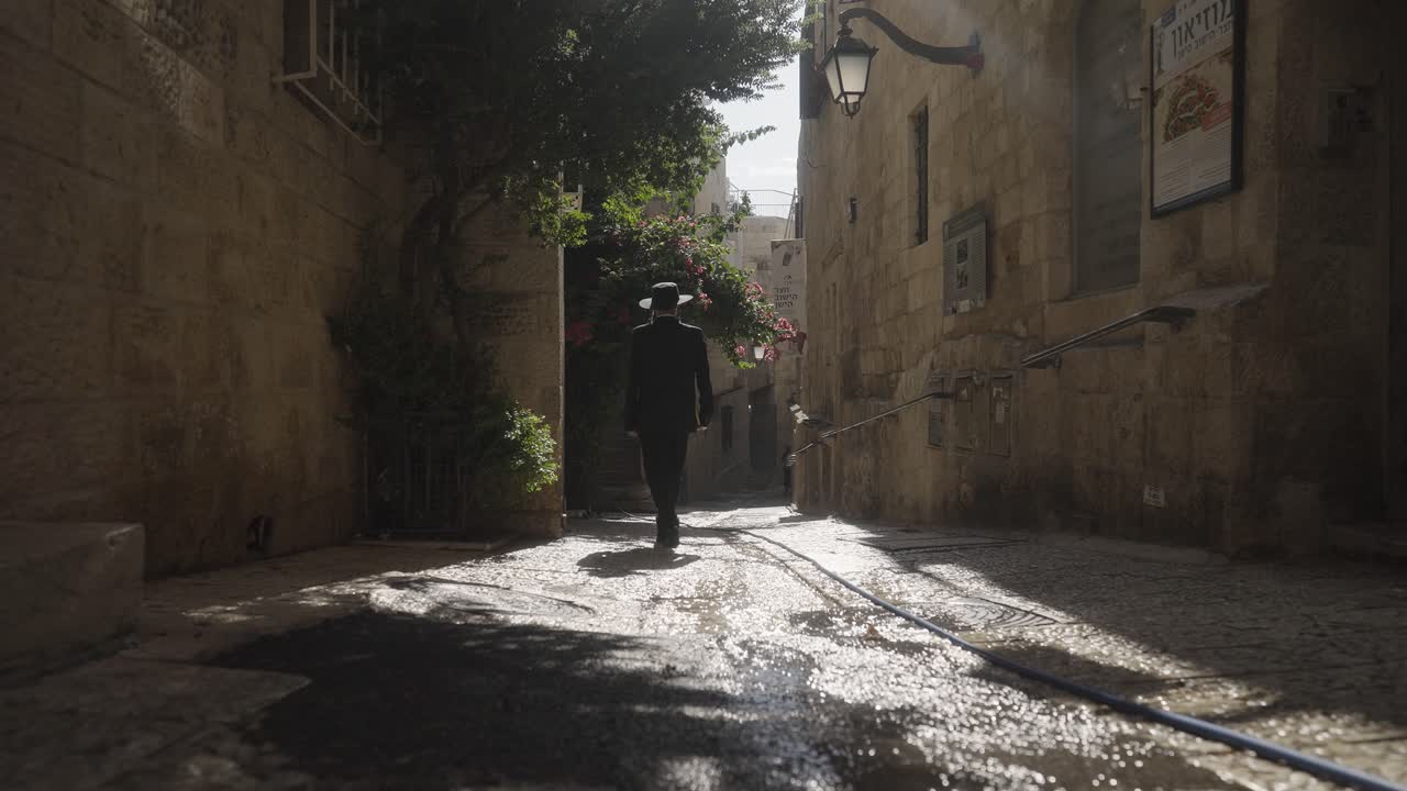 An Orthodox Jewish man walks through old streets of Jerusalem