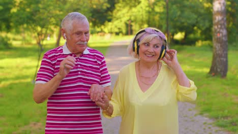 Älteres-Stilvolles-Paar-Familie-Großmutter-Großvater-Tanzen-Gehen-Musik-Hören-Im-Sommerpark