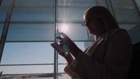 A-Passenger-With-A-Boarding-Pass-In-His-Hands-Is-Standing-At-A-Large-Window-Of-The-Airport-Terminal