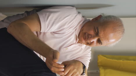 vertical video of suicide old man leaning against the wall.