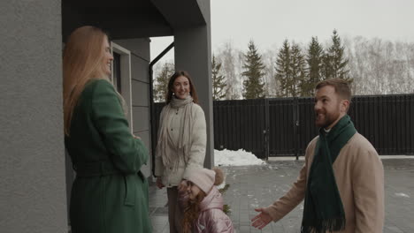 real estate agent showing house to family