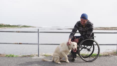 man in a wheelchair enjoying free time with his dog