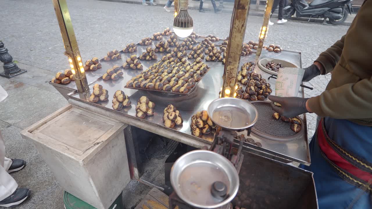 Roasted Chestnuts on a Street Vendor Cart in a City