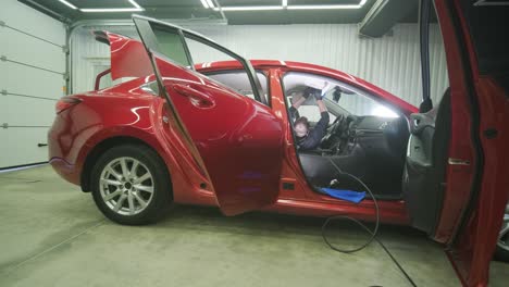 professional car cleaning. сar wash. interior detailing. dry clean and detail a car interior. deep cleaning of the car body and seats. wiping foam in car wash. cleaning the car panel from dust. a vacuum cleaner