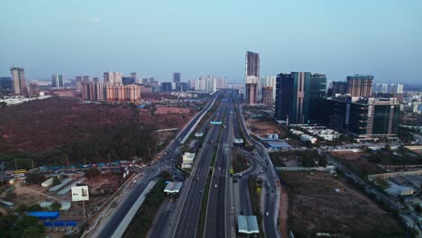 outer ring road exit 1 with financial district area and buildings at nanakramguda, hyderabad, telangana, india. day time, push in, drone shot, 4k.