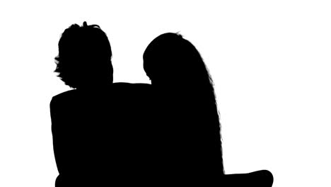 silhouette mother and daughter reading book on the couch track matte