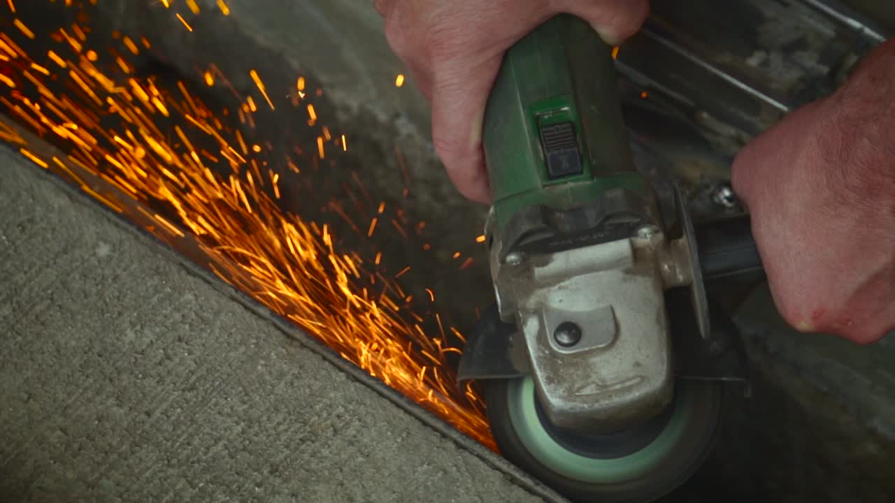 sawing and smoothing metal with a lot of sparkles in slow motion