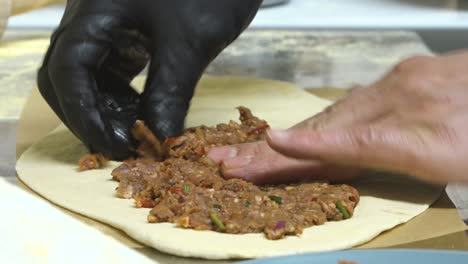 preparing a traditional turkish baked pide dish