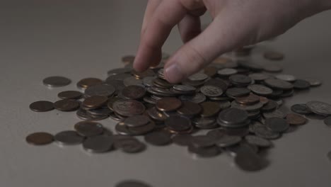 extreme slow motion clip of an individual picking up coins