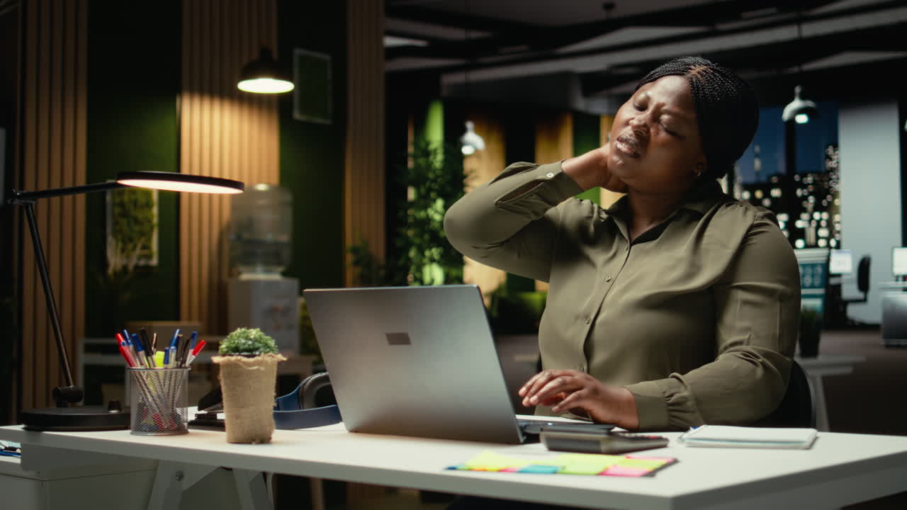 Businesswoman correcting her pose and stretching her neck muscles