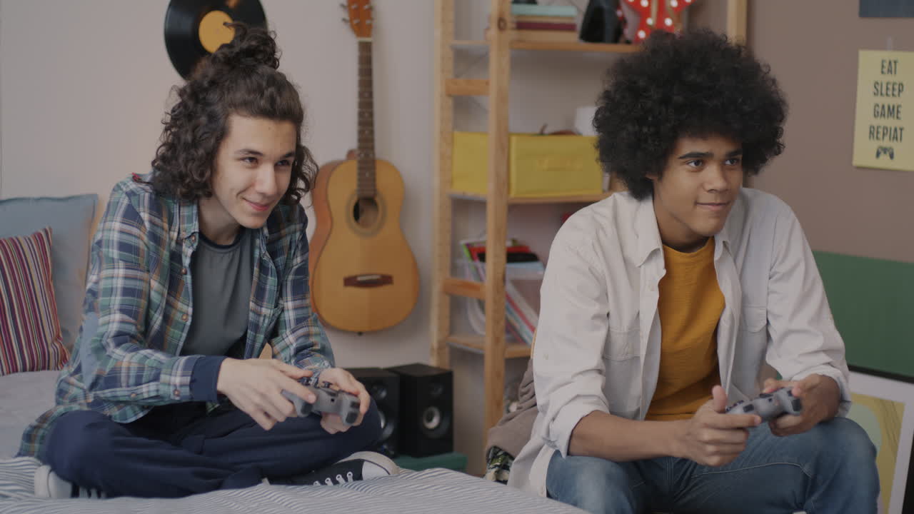 Teenagers Playing Video Games in Bedroom
