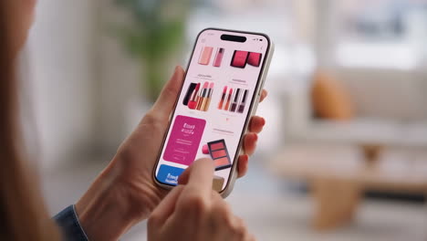 person browsing makeup products on a mobile e-commerce app
